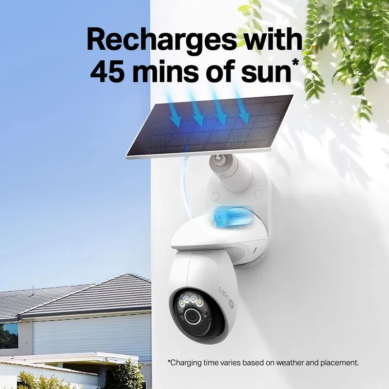 Solar panel charging a wireless security camera mounted on an exterior wall